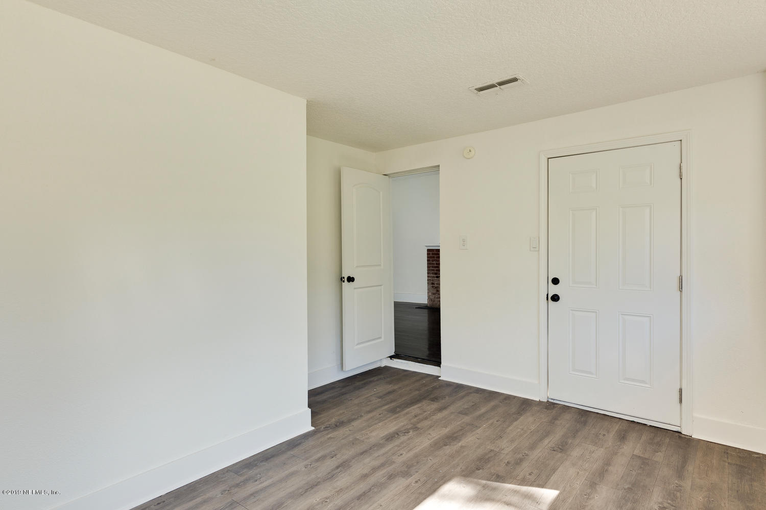 9301 Joos Road Jacksonville, FL 32220 - Photo 25 of 37 a view of an empty room with wooden floor