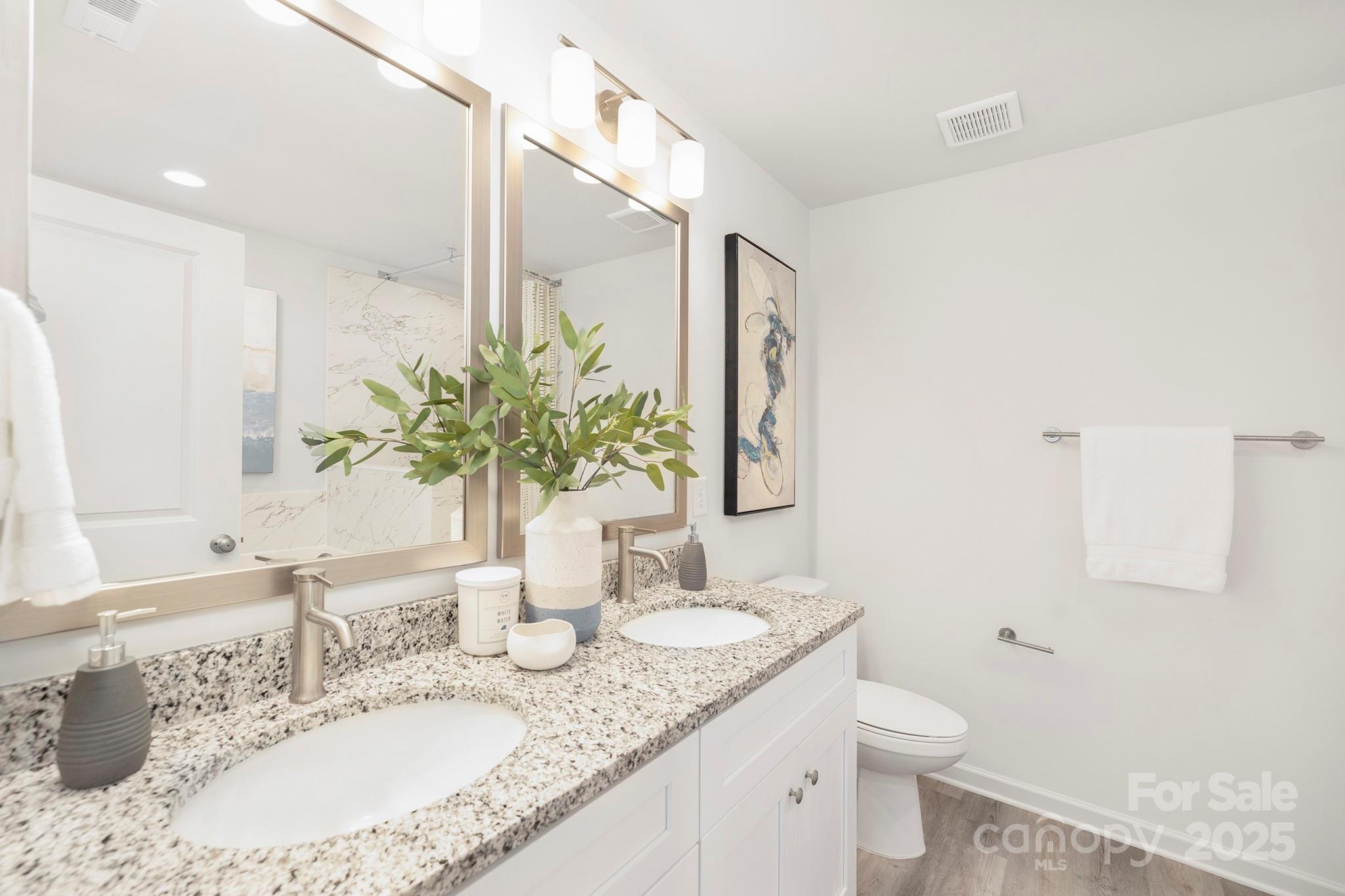 7601 Boswell Road Charlotte, NC 28215 - Photo 17 of 22 a bathroom with a granite countertop sink and a mirror