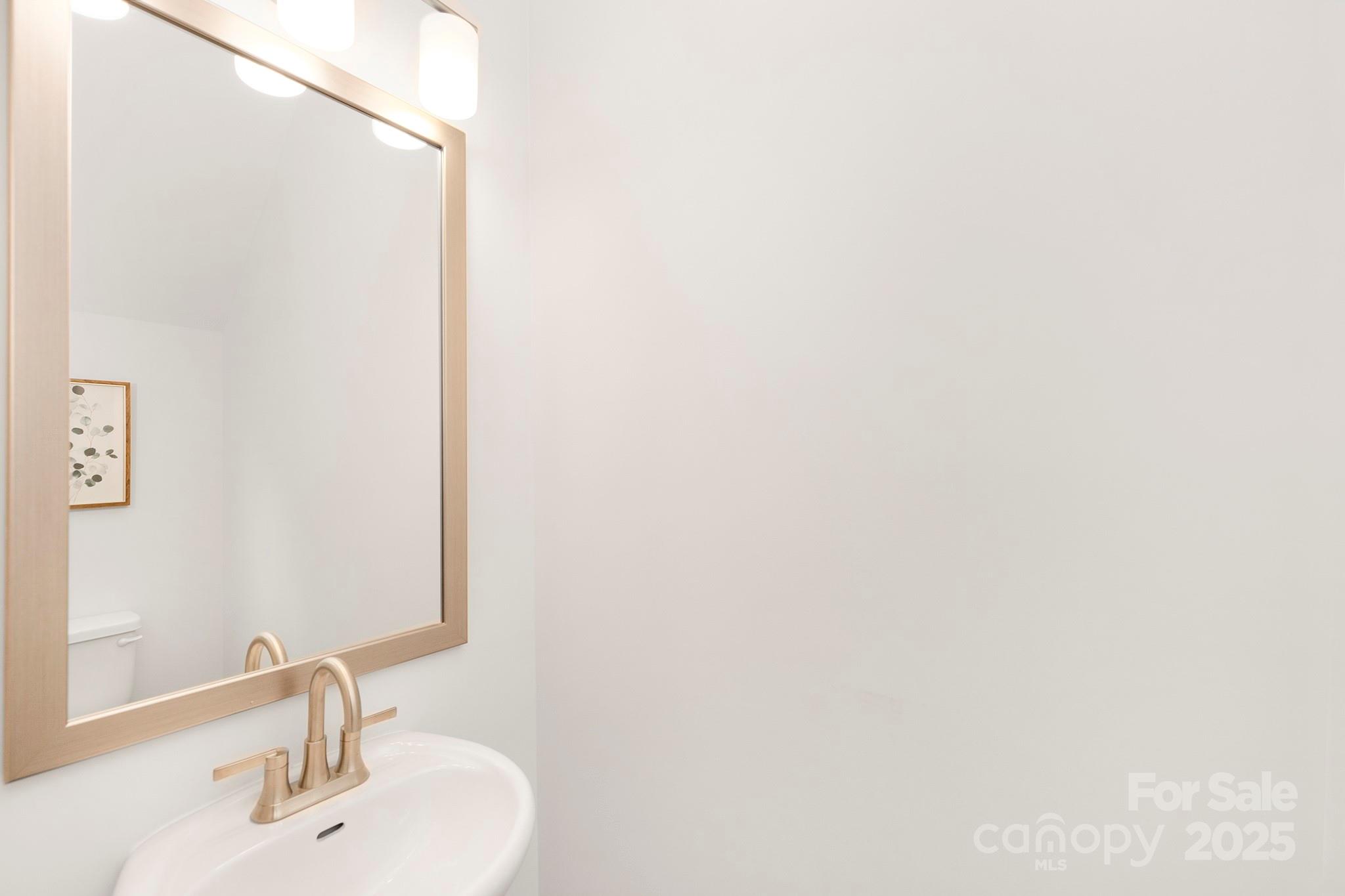 7601 Boswell Road Charlotte, NC 28215 - Photo 19 of 22 a bathroom with a sink and a mirror