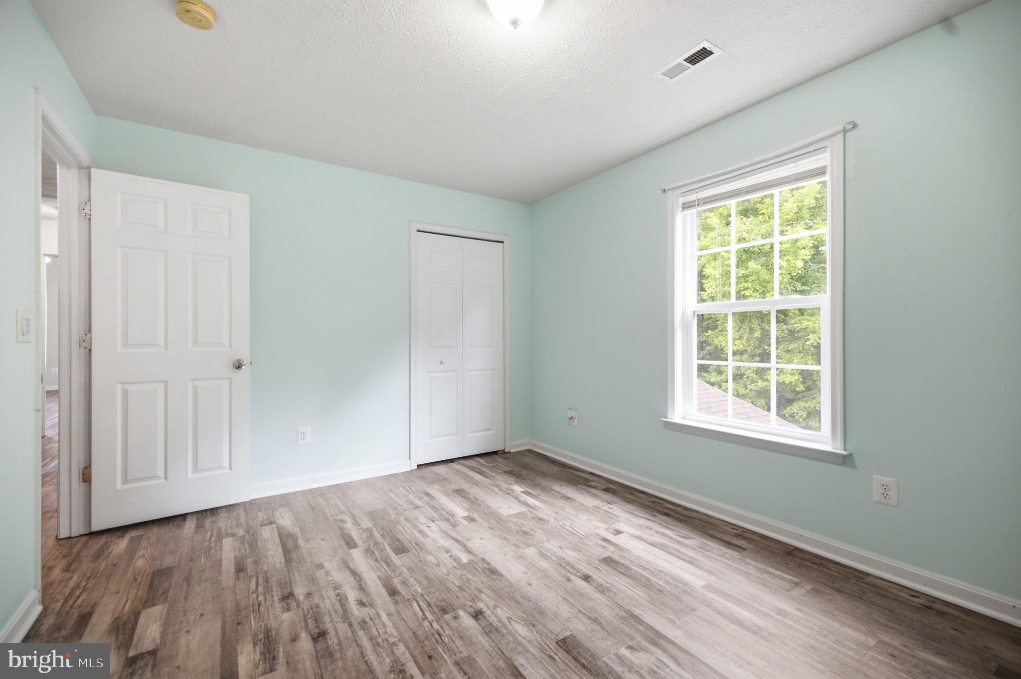 35338 Pheasant Ridge Road Locust Grove, VA 22508 - Photo 35 of 39 a view of an empty room with wooden floor and a window