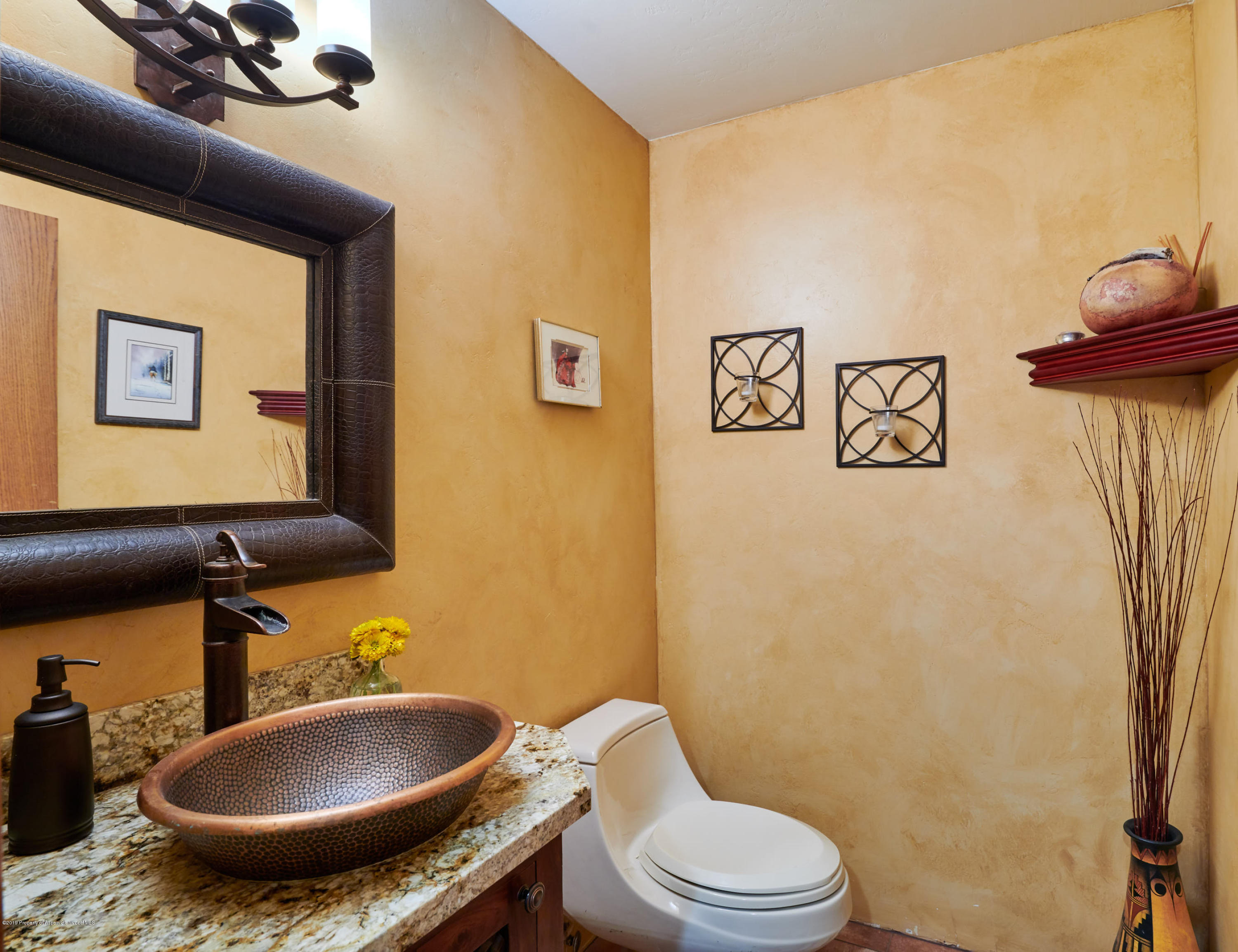 703 Holland Hills Road Basalt, CO 81621 - Photo 27 of 34 a bathroom with a toilet sink and mirror
