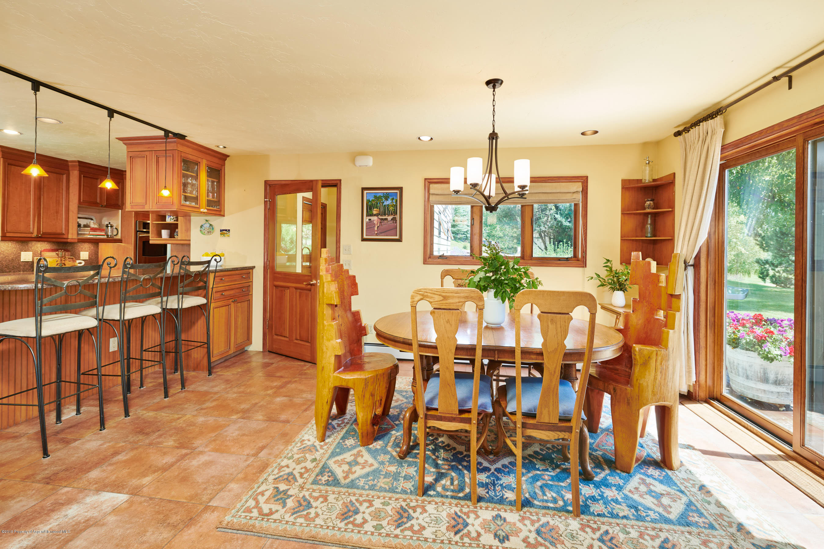 703 Holland Hills Road Basalt, CO 81621 - Photo 10 of 34 a view of a dining room with furniture window and wooden floor