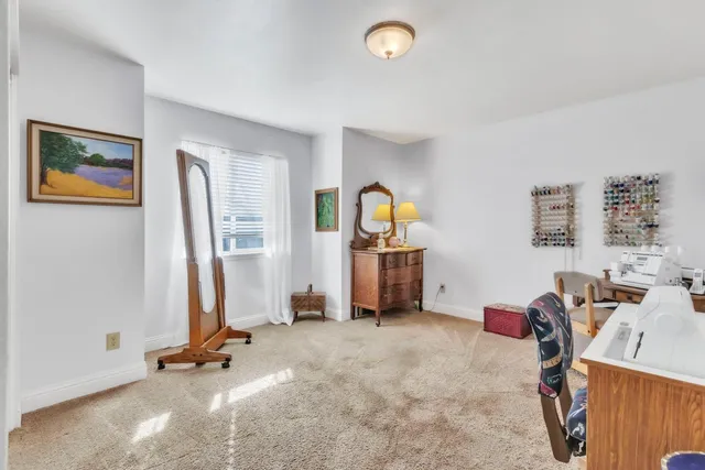 a front view of a house with a garden and trees