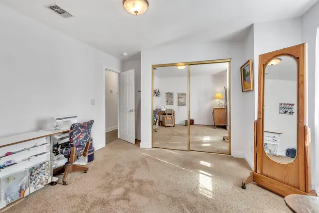 a view of a yard with plants and trees