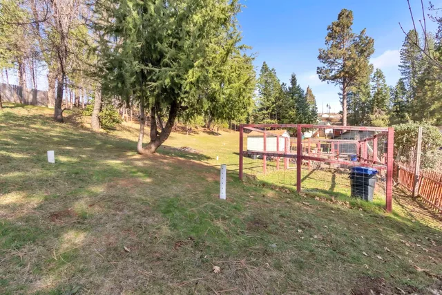 a view of a patio with table and chairs under an umbrella
