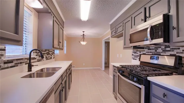 a kitchen that has a sink and a stove