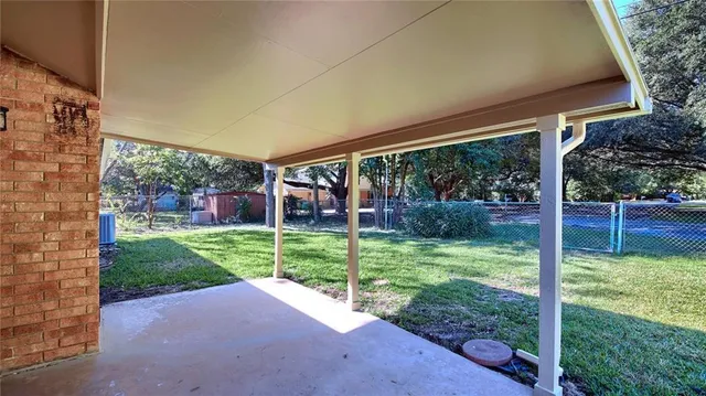 a view of a house with backyard and porch