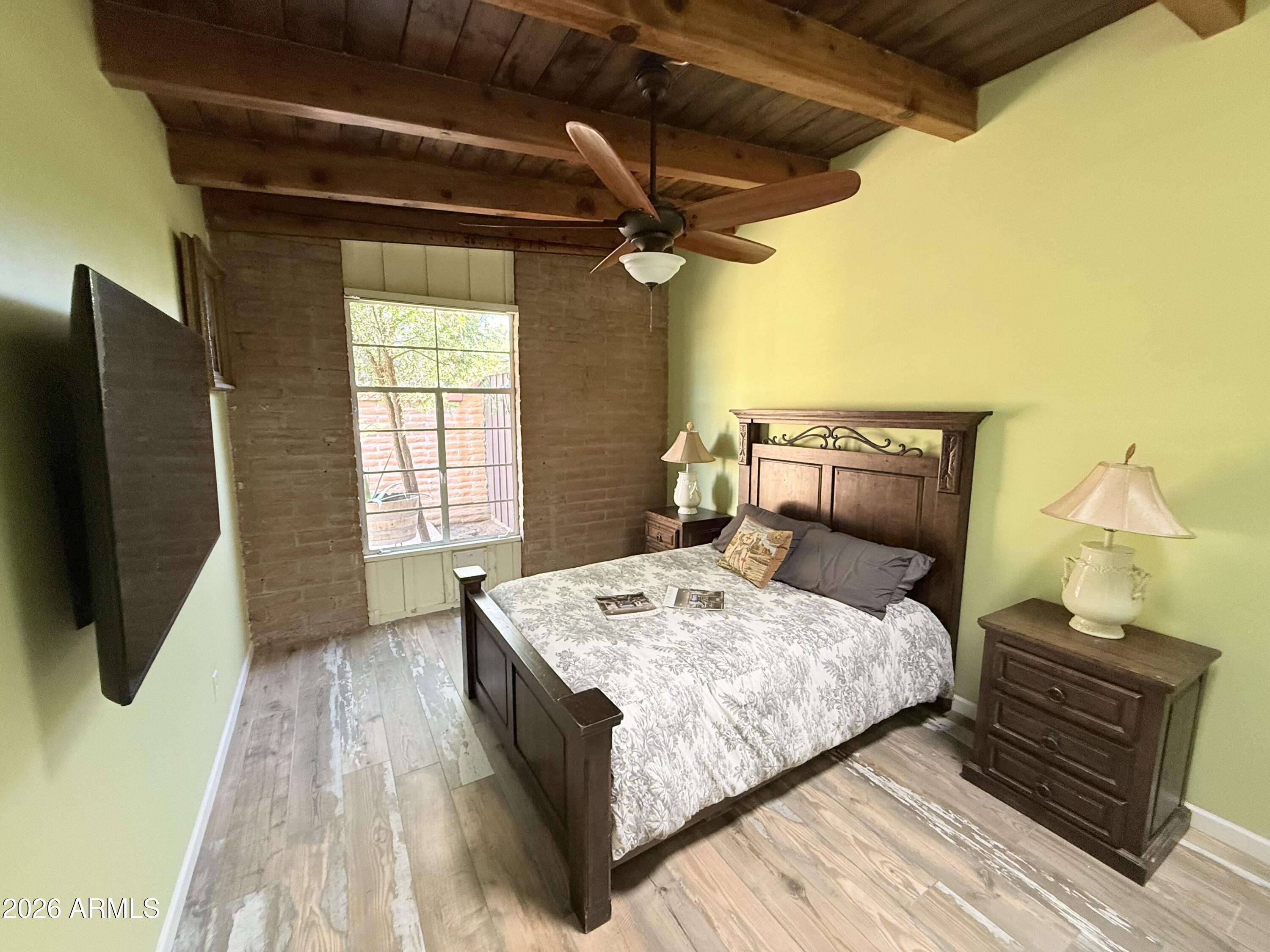 3032 North 32nd Street, Unit 65 Phoenix, AZ 85018 - Photo 12 of 22 a bedroom with a bed a flat screen tv and window