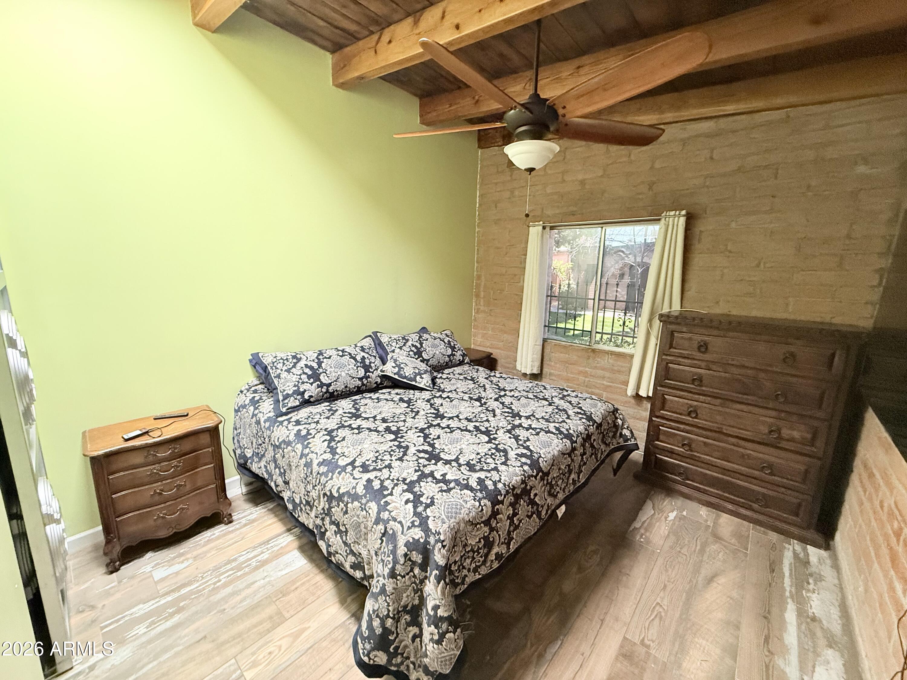 3032 North 32nd Street, Unit 65 Phoenix, AZ 85018 - Photo 13 of 22 a bed sitting in a bedroom next to a window