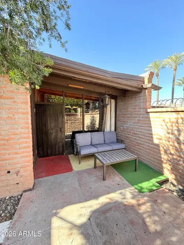 a view of a bench in the back yard of a house