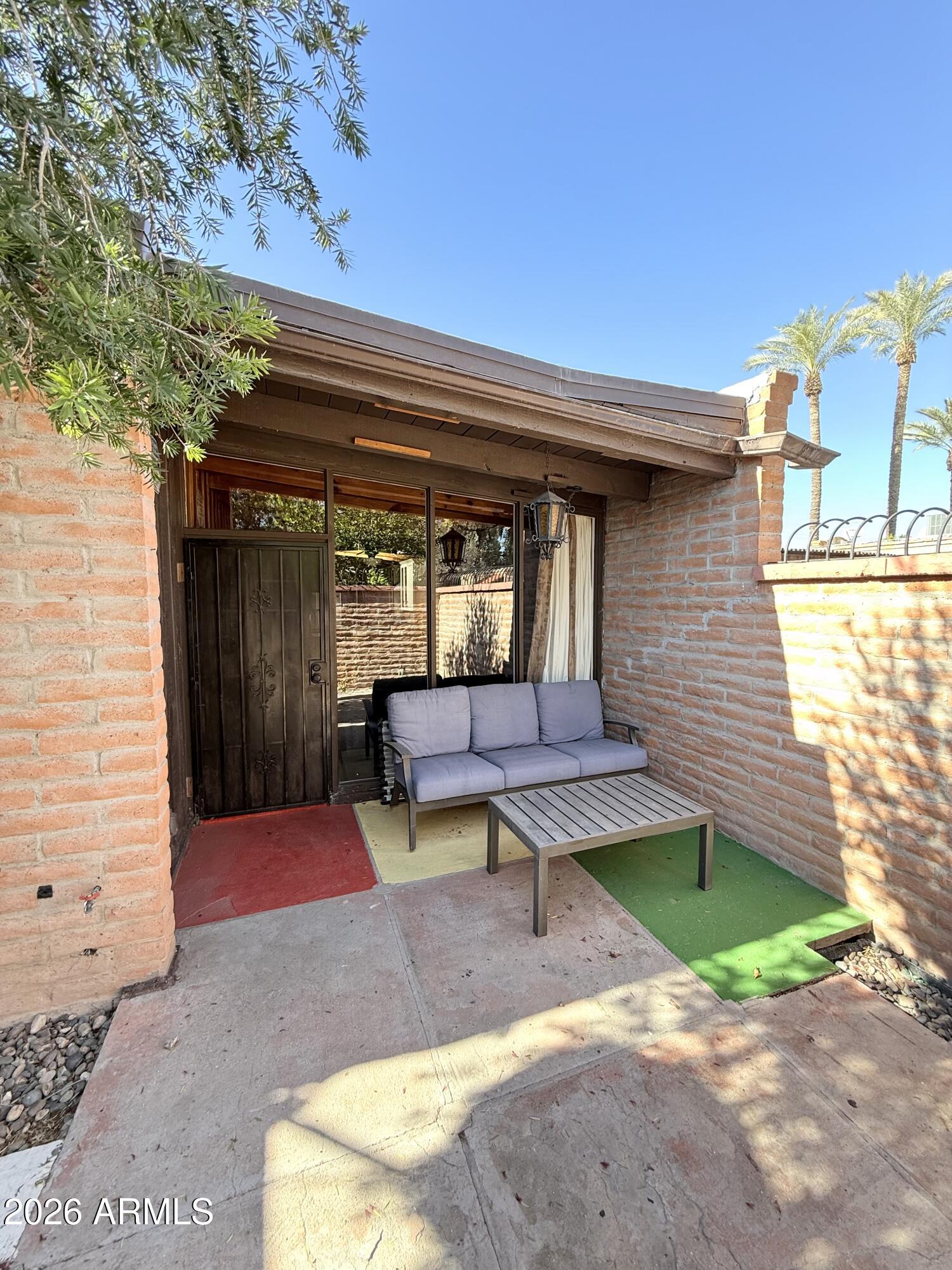 3032 North 32nd Street, Unit 65 Phoenix, AZ 85018 - Photo 16 of 22 a view of a bench in the back yard of a house