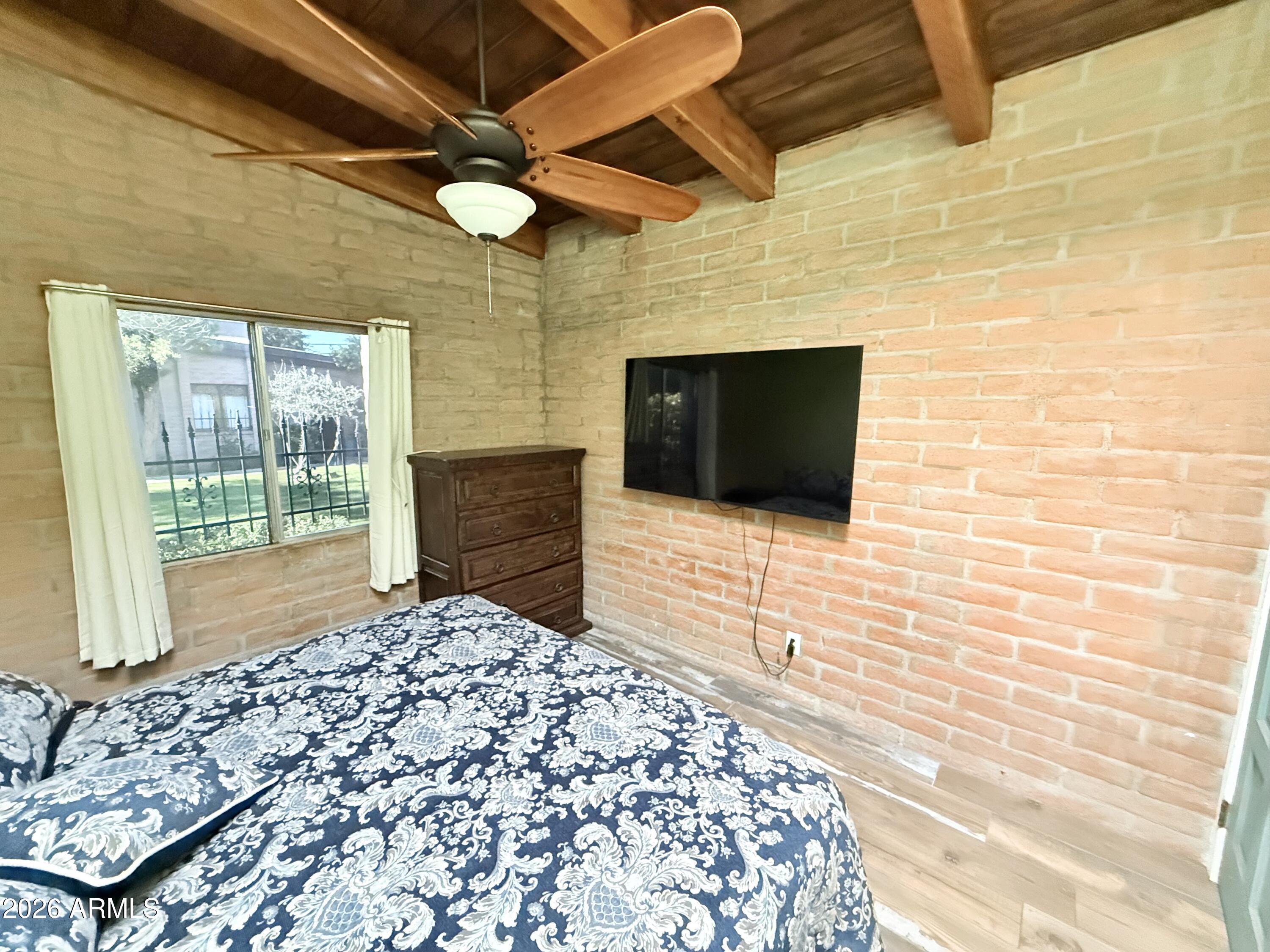 3032 North 32nd Street, Unit 65 Phoenix, AZ 85018 - Photo 9 of 22 a room with a bed and a flat screen tv