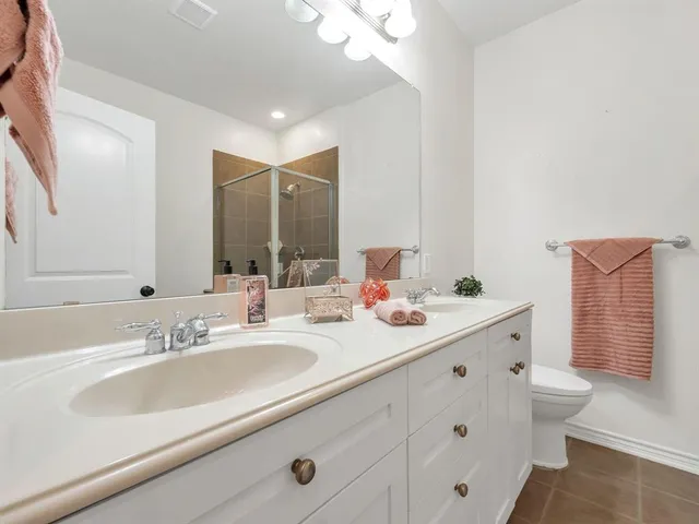 a bathroom with a double vanity sink mirror and