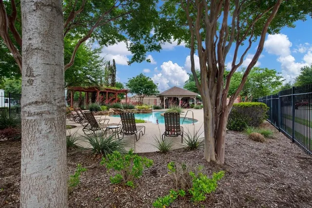 a view of a house with backyard and sitting area