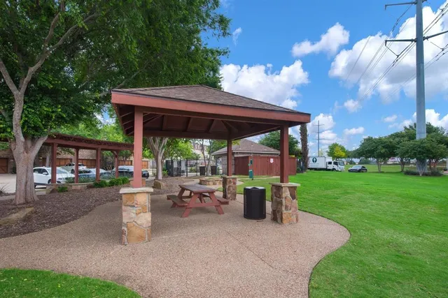 a patio with wooden table and chairs