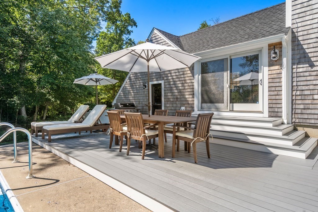 14 Sassamon Road Scituate, MA 02066 - Photo 19 of 28 a view of a patio with table and chairs with wooden floor and fence
