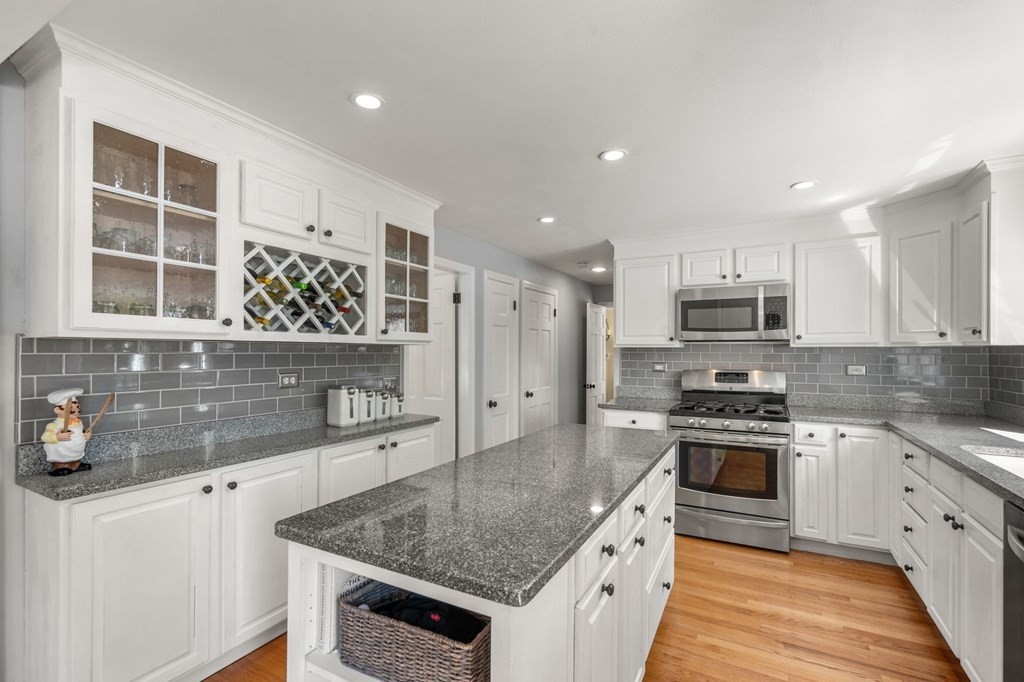 14 Sassamon Road Scituate, MA 02066 - Photo 7 of 28 a kitchen with stainless steel appliances granite countertop a sink stove and refrigerator