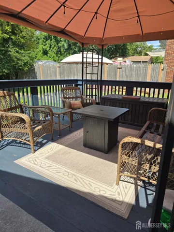 a roof deck with a table and chairs under an umbrella
