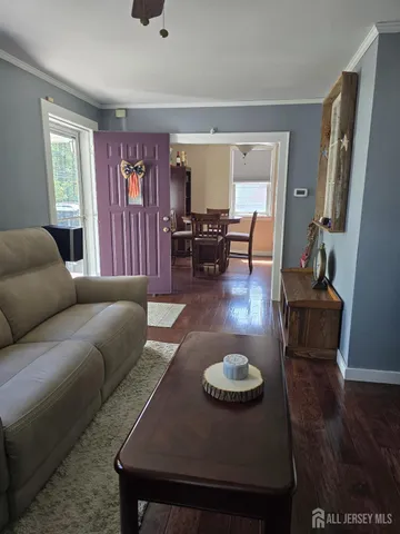a living room with furniture rug and wooden floor