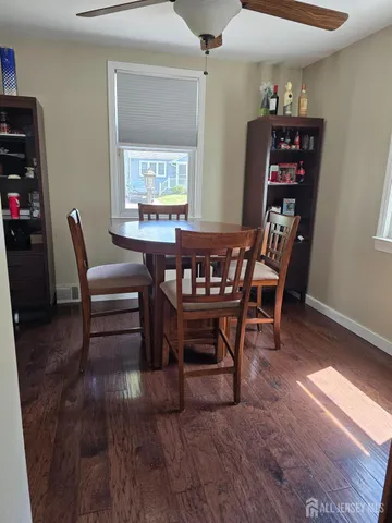 a dining room with furniture and wooden floor
