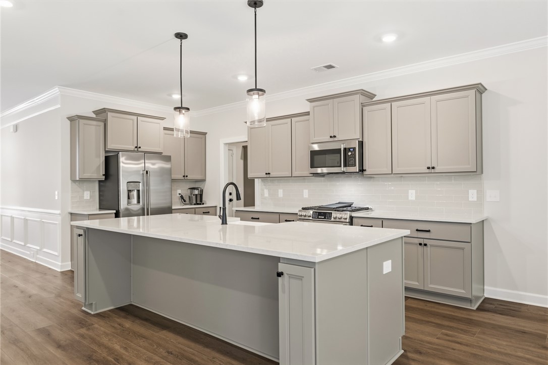 701 Weathered Oak Way Anderson, SC 29621 - Photo 5 of 41 This modern kitchen features a spacious island and contemporary appliances, perfect for everyday living.