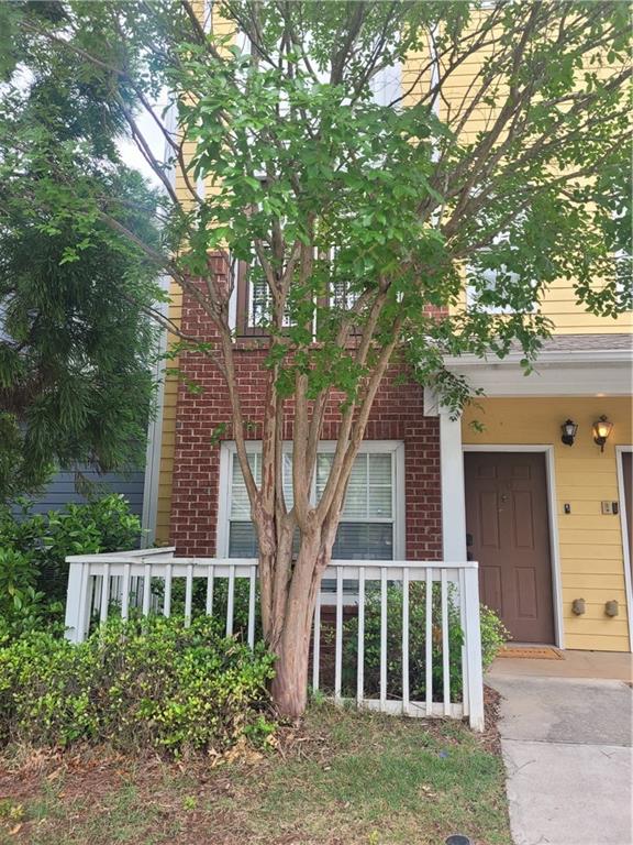 1732 Pryor Road Southwest, Unit 410 Atlanta, GA 30315 - Photo 1 of 1 front view of a house with a tree