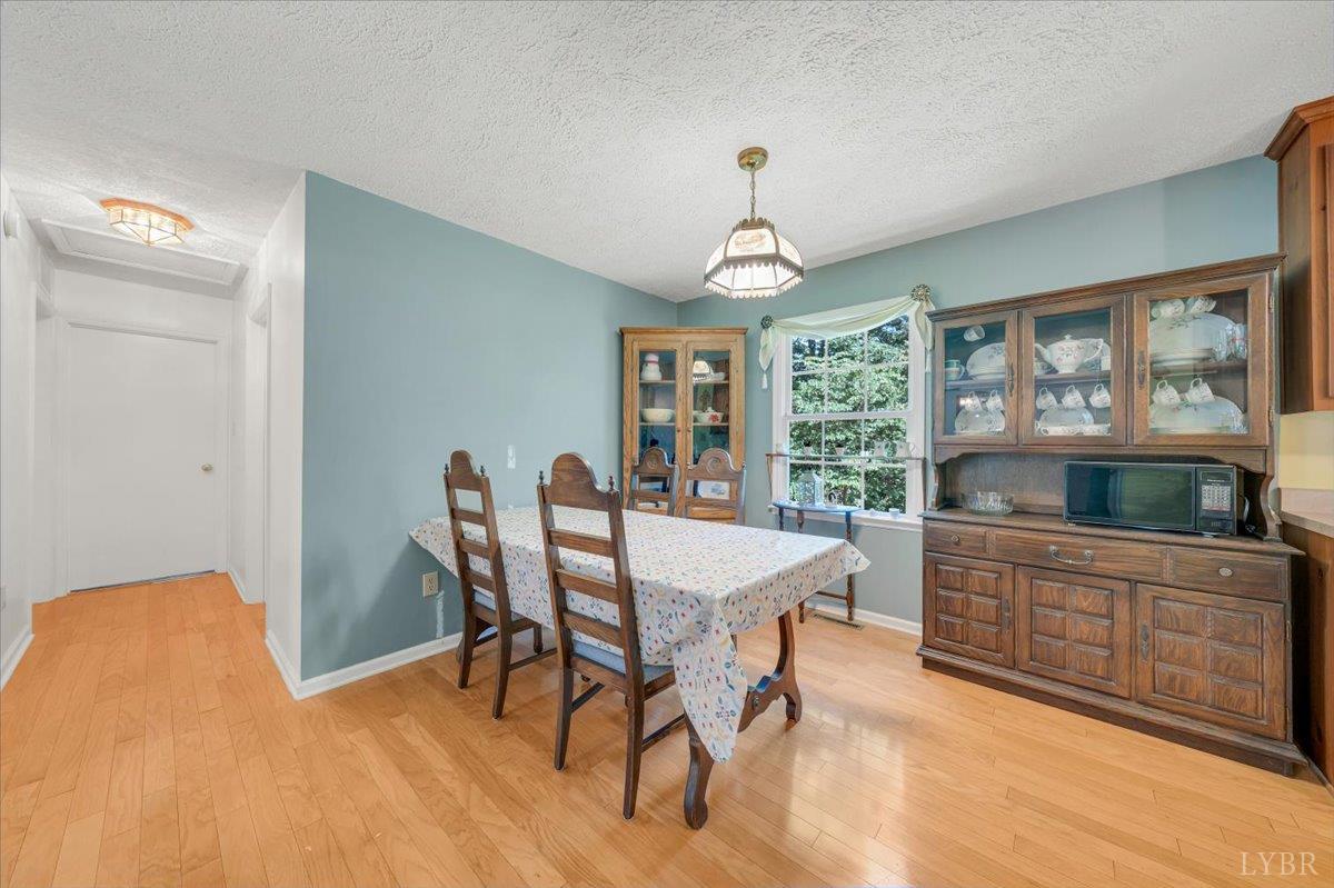 1124 Homeplace Road Bedford, VA 24523 - Photo 9 of 47 a view of a dining room with furniture window and wooden floor