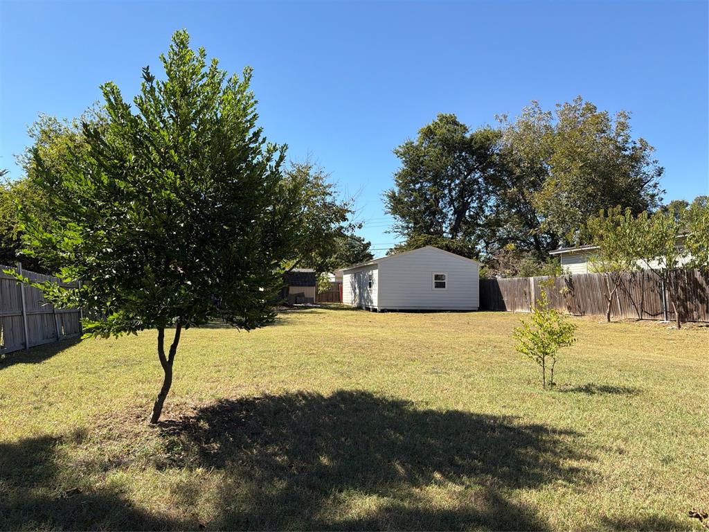 5127 Cardiff Street Dallas, TX 75241 - Photo 9 of 11 a large tree in front of a yard with wooden fence