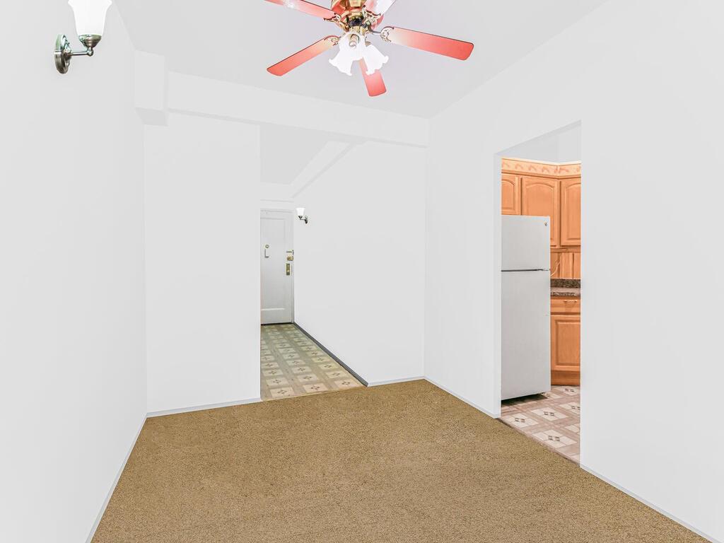 1510 Archer Road, Unit MF Bronx, NY 10462 - Photo 3 of 10 a view of a hallway with a chandelier fan and a window