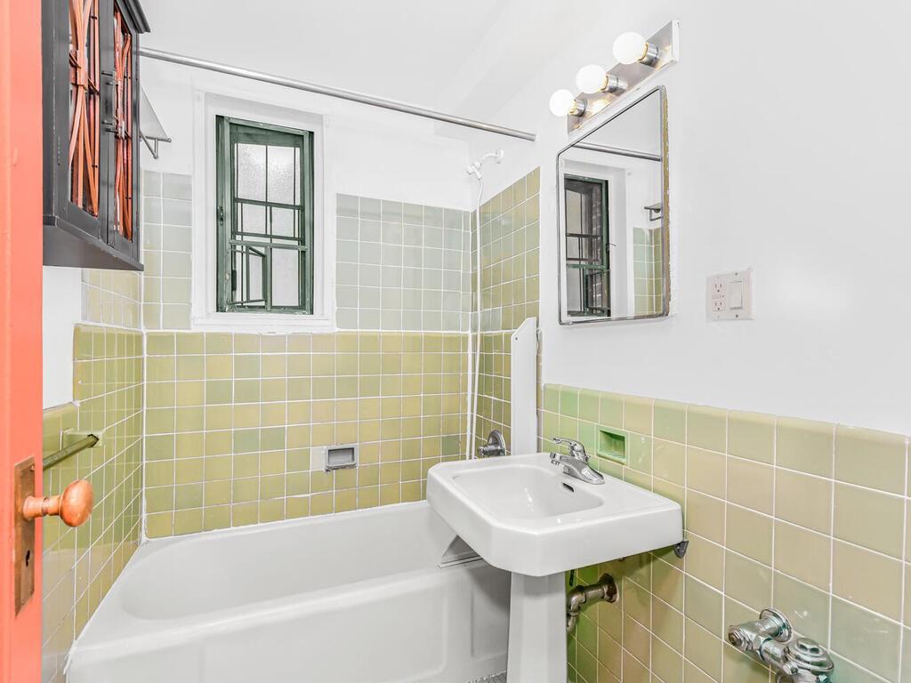1510 Archer Road, Unit MF Bronx, NY 10462 - Photo 6 of 10 a bathroom with a sink a bathtub and a shower