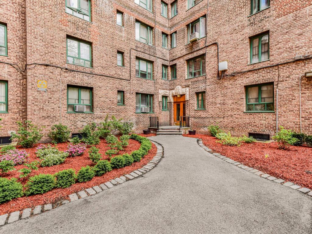 1510 Archer Road, Unit MF Bronx, NY 10462 - Photo 9 of 10 front view of a brick house with a yard