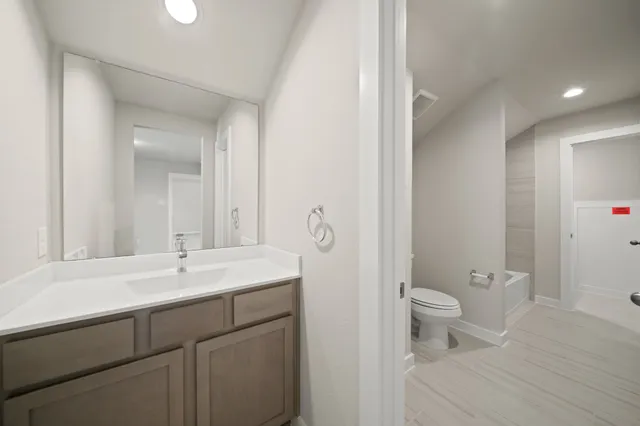 a bathroom with a bathtub shower sink and mirror