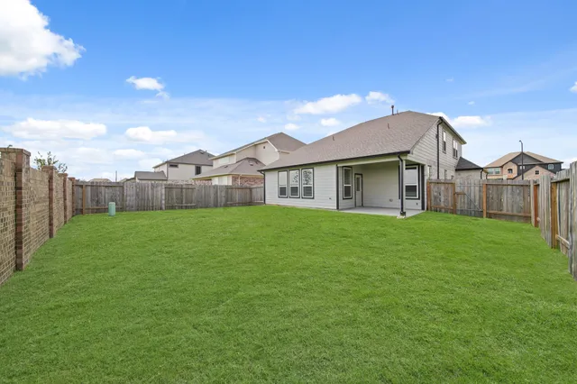 a view of a swimming pool with a garden and seating area