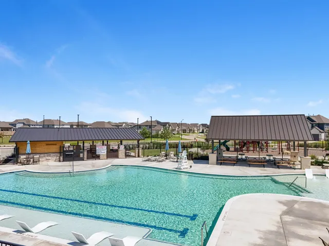 a view of a swimming pool with seating area