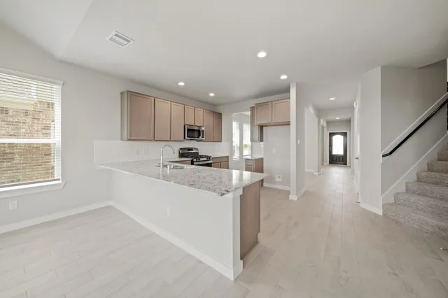 a view of a kitchen with a sink and dishwasher