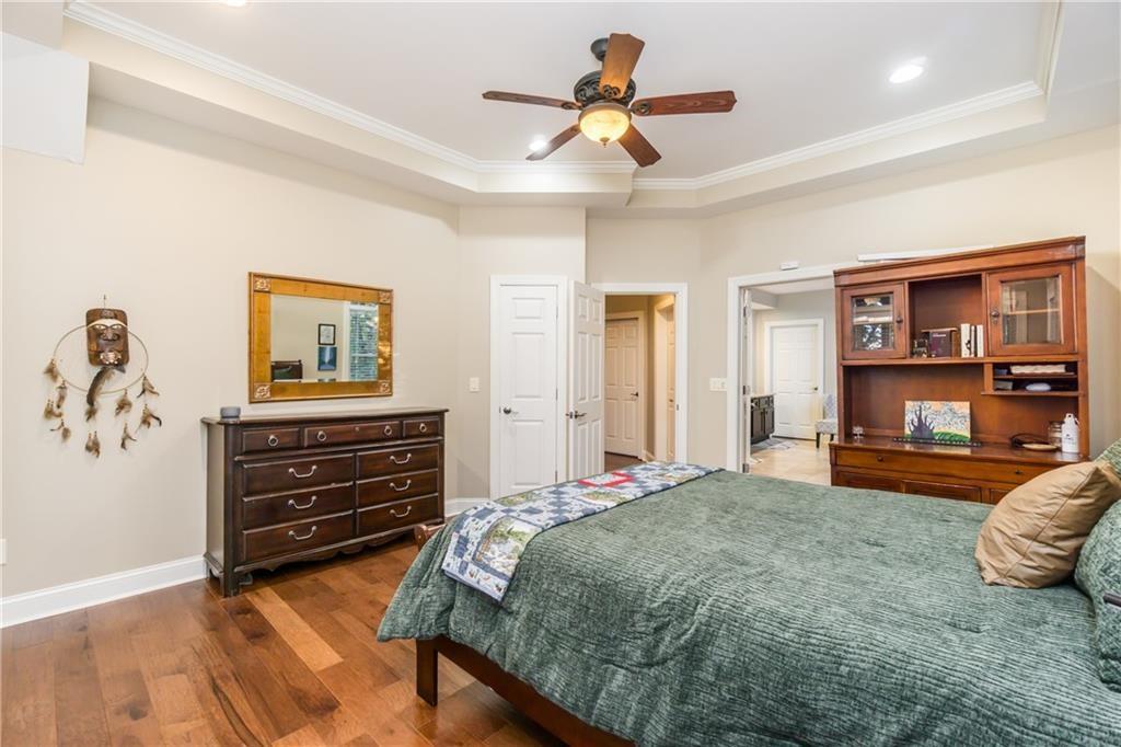 2819 Point Overlook Gainesville, GA 30501 - Photo 46 of 71 a bedroom with a bed and a chandelier