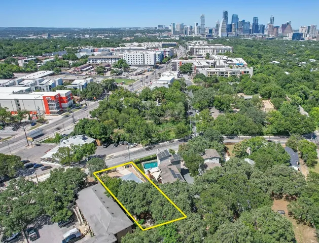 an aerial view of a house with a yard and lake view