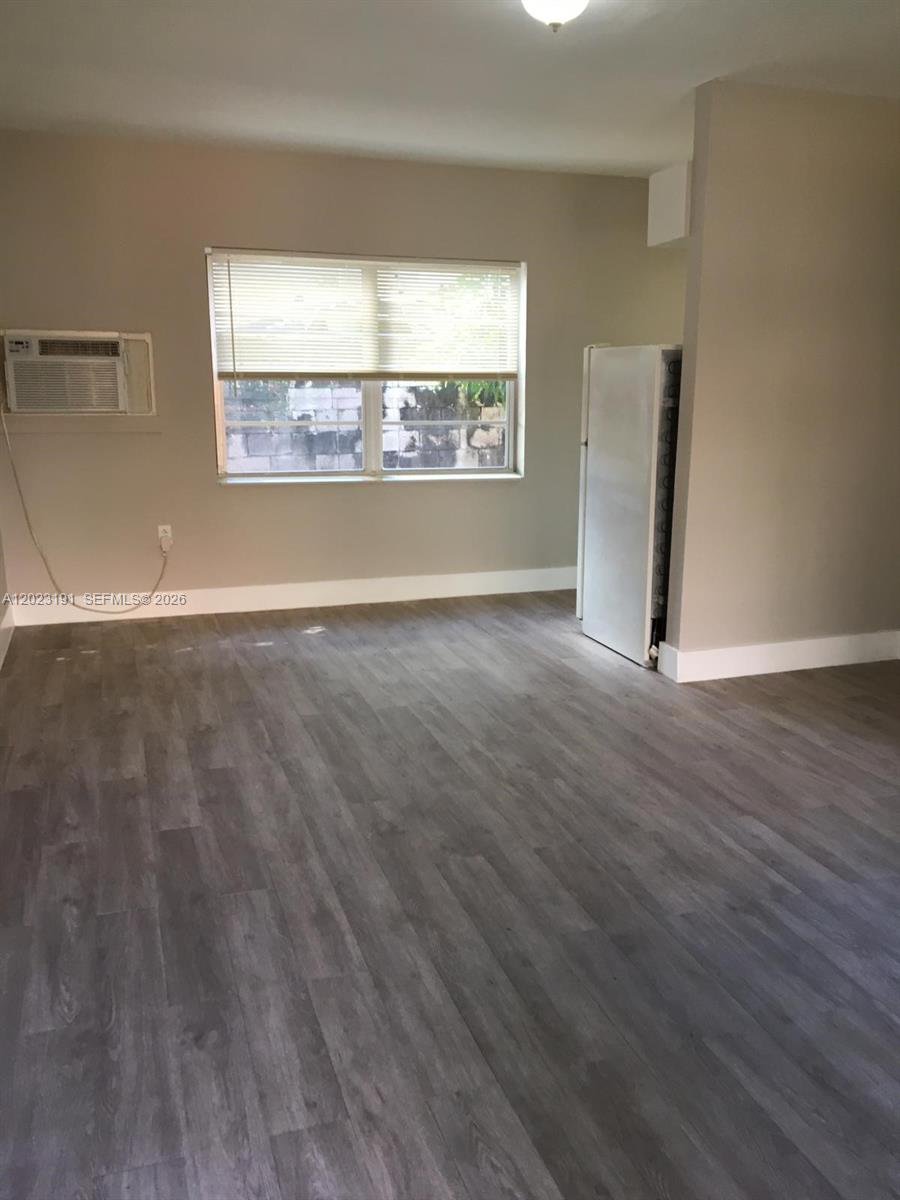 520 Southwest 4th Street, Unit 5 Miami, FL 33130 - Photo 2 of 11 an empty room with wooden floor and windows