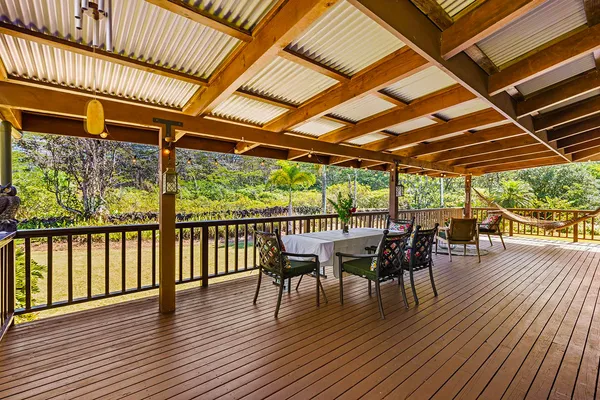 a view of a patio with table and chairs and wooden floor