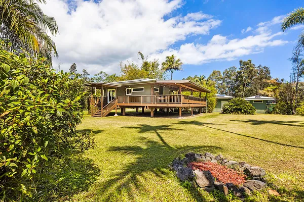 a view of a swimming pool with an outdoor seating and a yard