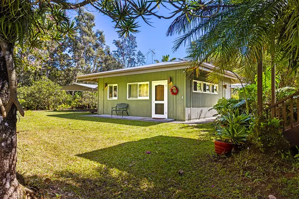 a view of a house with pool and sitting area