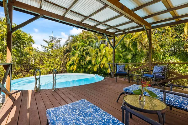 a balcony with wooden floor table and chairs