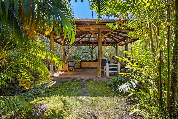 a backyard of a house with table and chairs