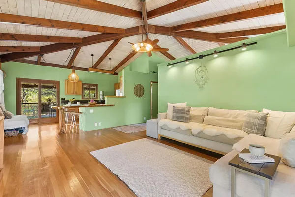 a living room with furniture and a wooden floor