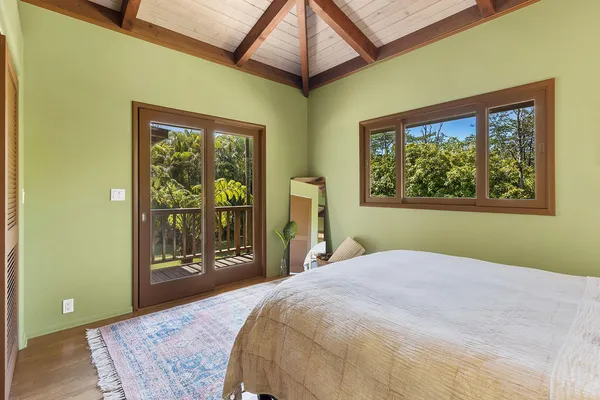 a bedroom with a bed and a large window