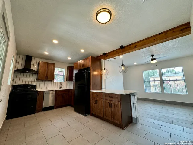 a kitchen with stainless steel appliances granite countertop a refrigerator and a sink