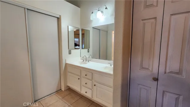 a bathroom with a double vanity sink and a mirror
