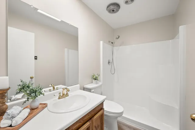 a bathroom with a sink toilet and shower