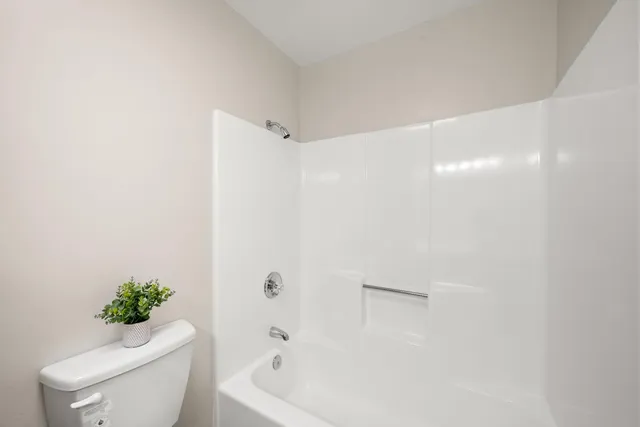 a wooden bench sitting in front of a building