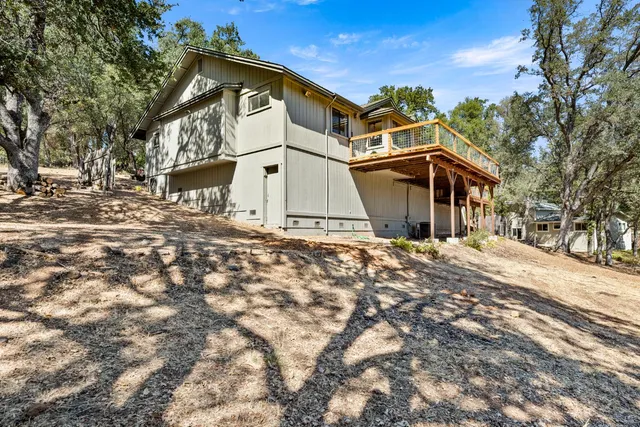a view of a house with a yard and sitting area